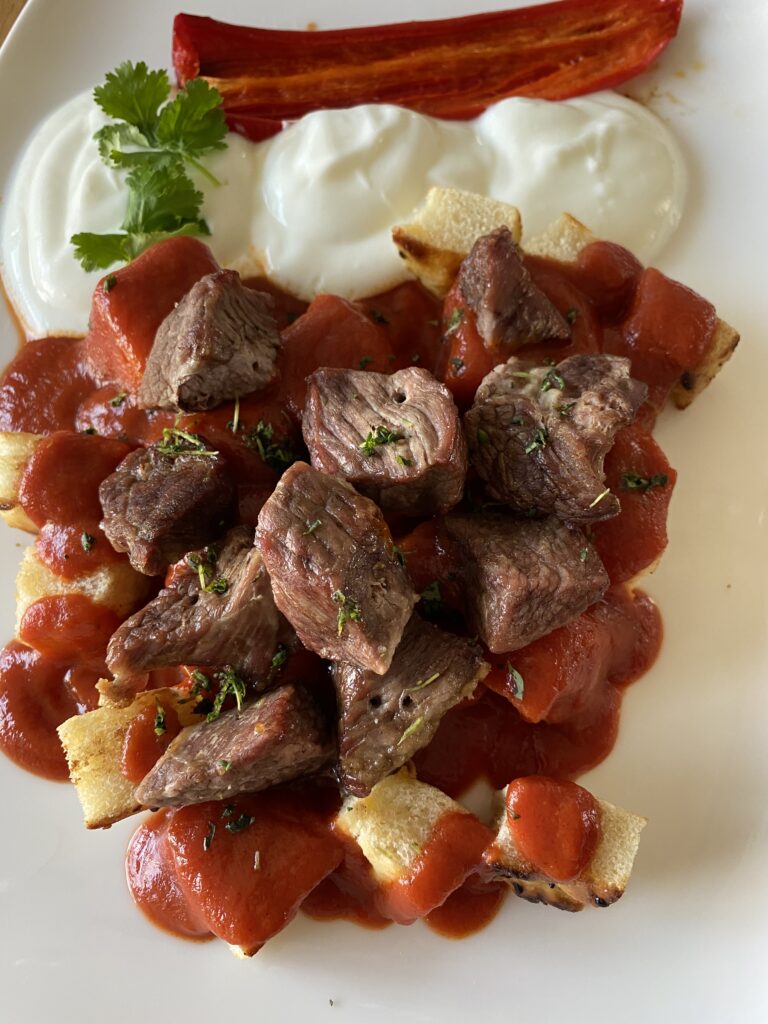 Iskender Kebap wird klassisch als Tellergericht serviert.